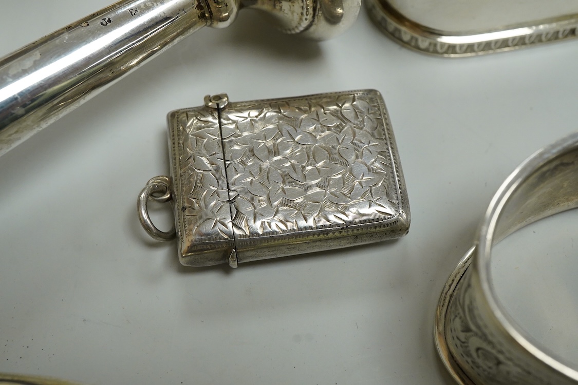 Three assorted silver napkin rings, a pair of recent 925 napkin rings, a George V silver mounted hand mirror, a modern silver mounted spill vase and a late Victorian silver vesta case.